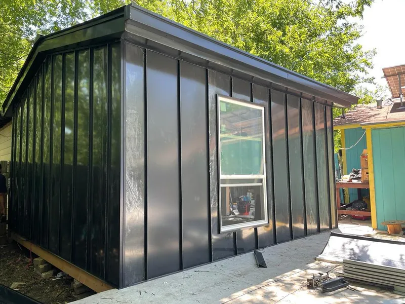 Black standing seam metal wall panels for Roof Inspection in Woolwich