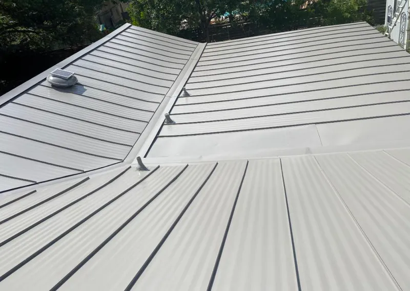 Solar attic fan installed on a metal roof for Roof Ventilation in Woolwich